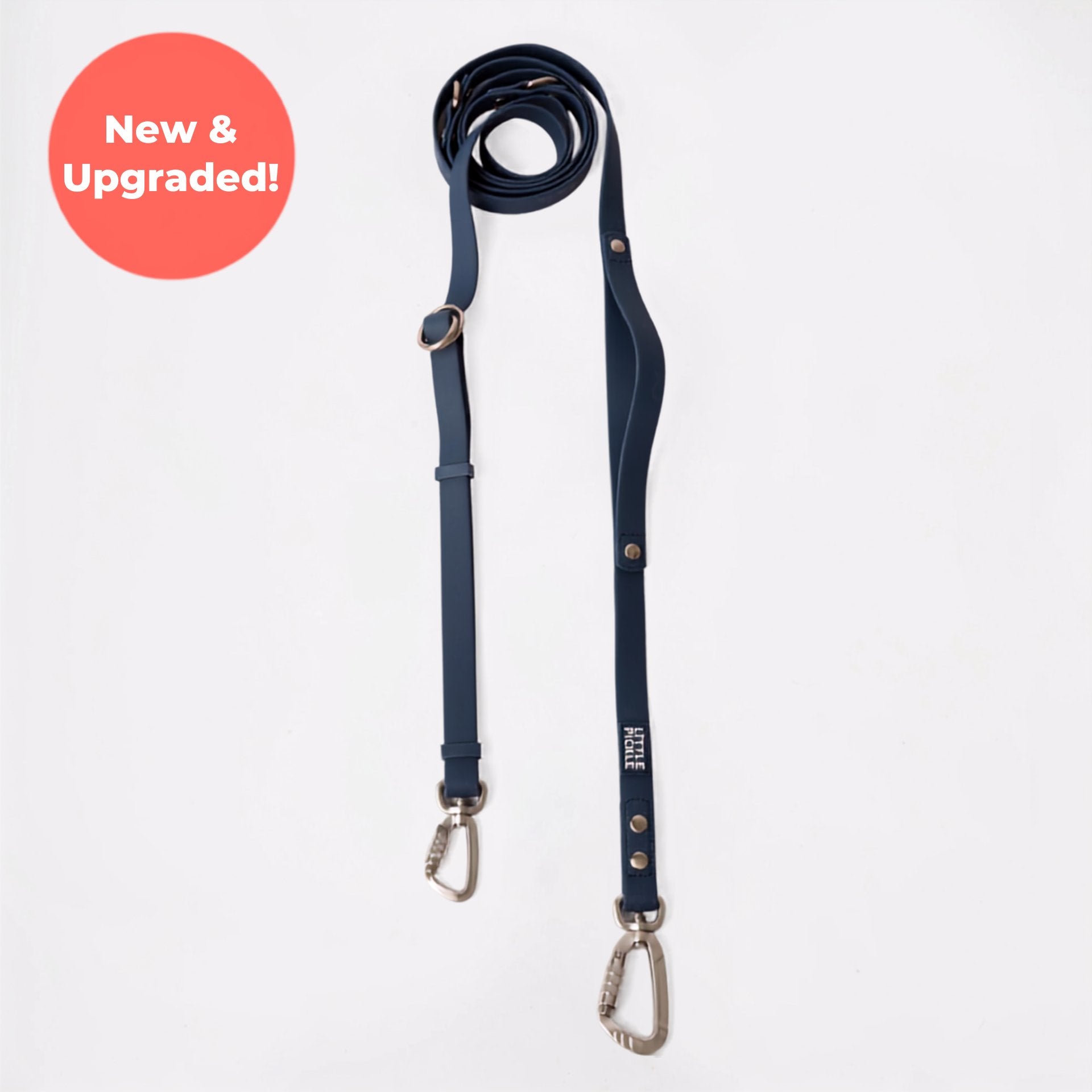 A navy blue leather dog leash with silver metal hardware, displayed vertically on a light gray background with a red circular 'New Colour!' badge in the top left corner.