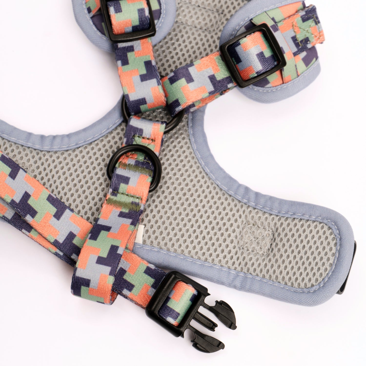 Colorful camo-patterned dog harness with breathable mesh panel, adjustable straps, and secure buckles